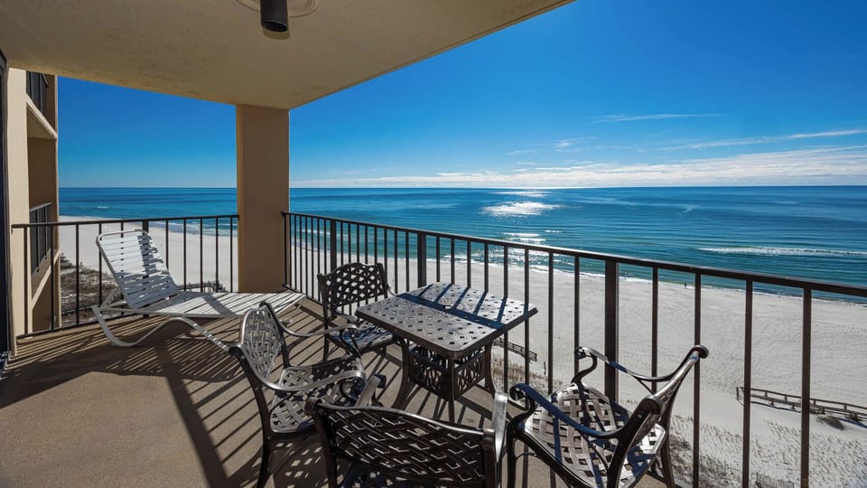 Relax on the balcony with stylish seating and breathtaking views of the sparkling shoreline and tranquil waters