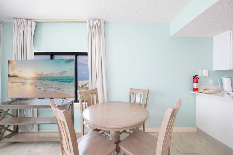 Enjoy meals at the round dining table while taking in the stunning views through the large sliding glass doors