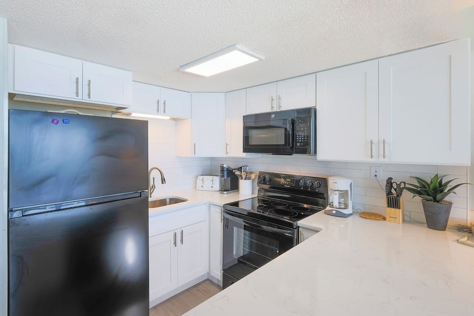 This kitchen features modern appliances and a bright, inviting atmosphere perfect for meal preparation and gatherings