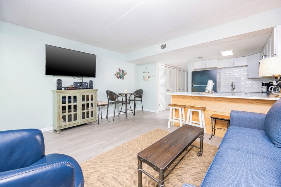 This inviting space features a cozy seating area with a view of the stylish kitchen and a welcoming atmosphere for relaxation