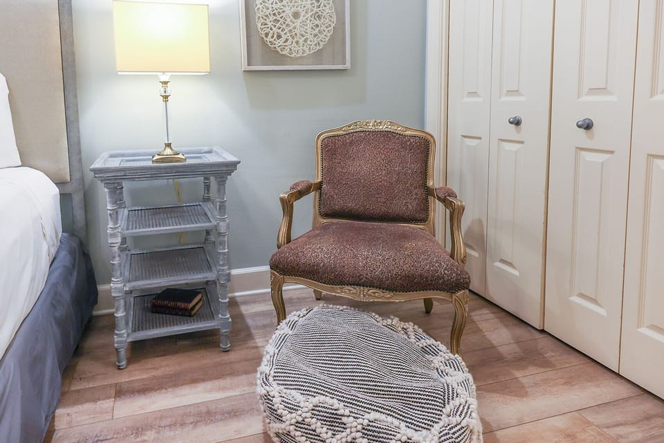 Relax in the charming chair with a book, as soft light and soothing decor create a cozy reading nook