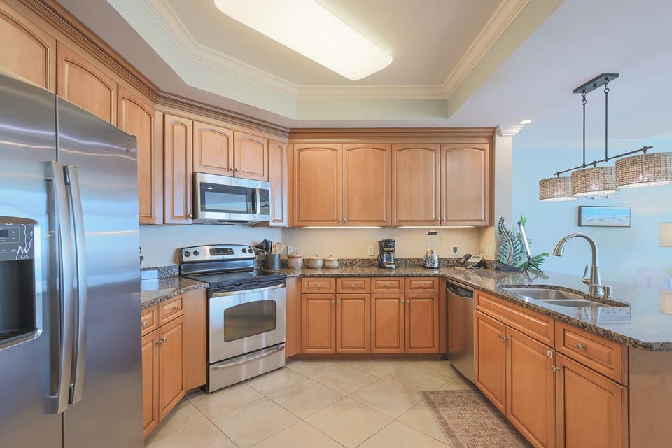 Prepare meals in this kitchen with elegant cabinetry, stainless appliances, and spacious countertops
