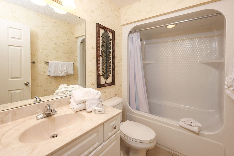 Freshen up in this guest bath in the relaxing shower or soothing tub before an exciting beach day