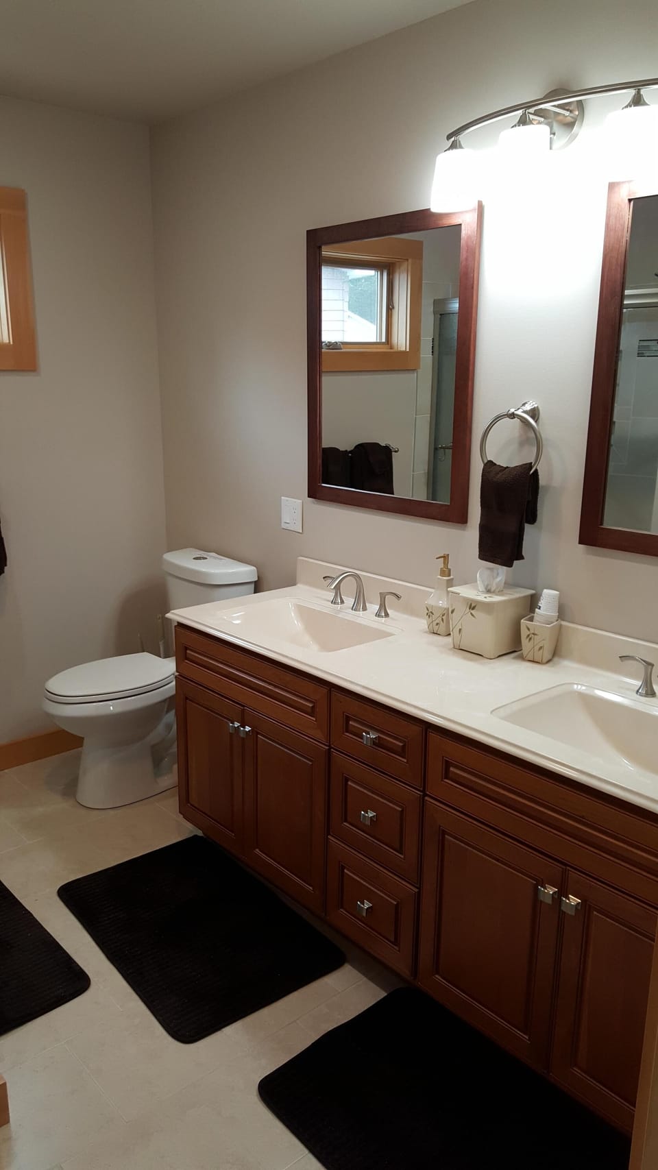 First floor full bathroom with a double vanity, shower, tub, hair dryer, etc.