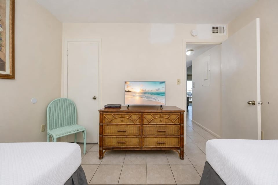 Twin beds in the guest suite offer a restful retreat where you can watch your favorite shows and unwind after the day