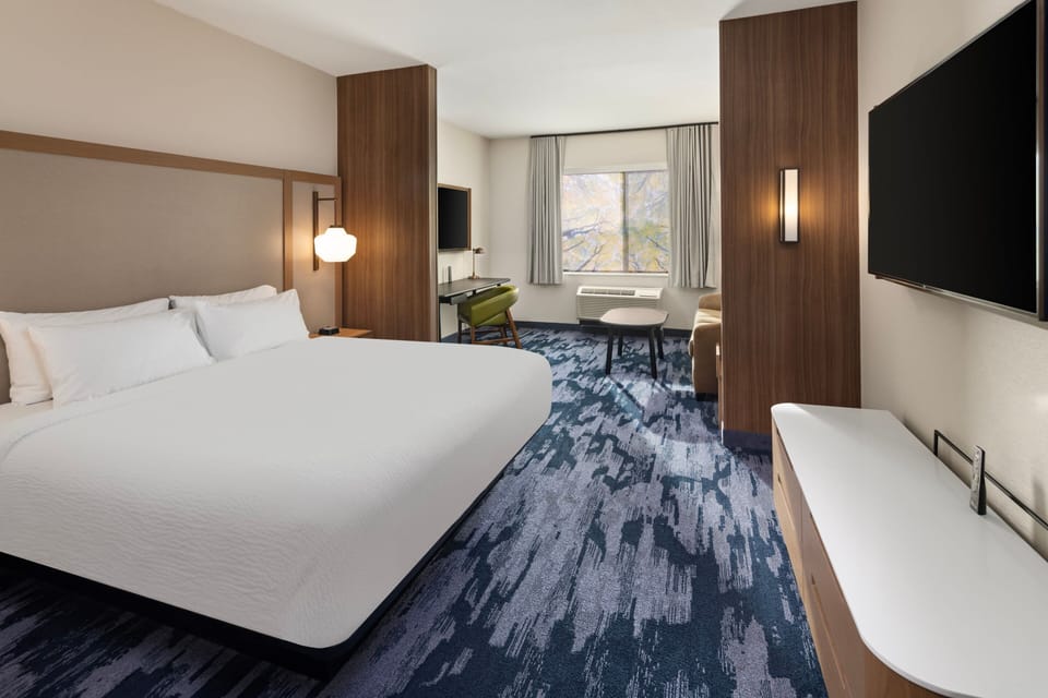 Premium bedding, desk, laptop workspace, blackout drapes
