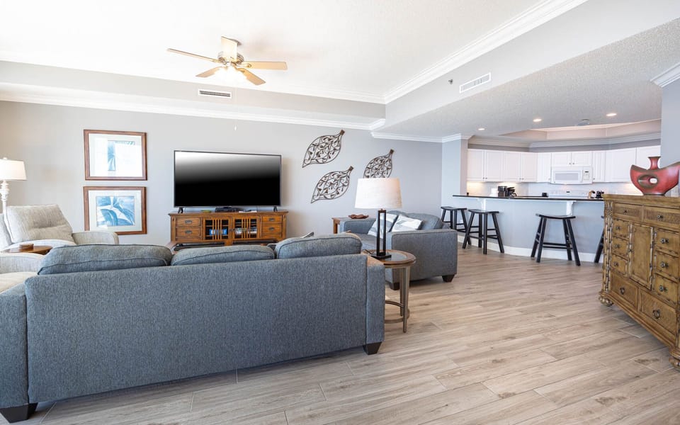 Relax on the comfortable sofa while enjoying family movie night on the large TV in your inviting coastal retreat