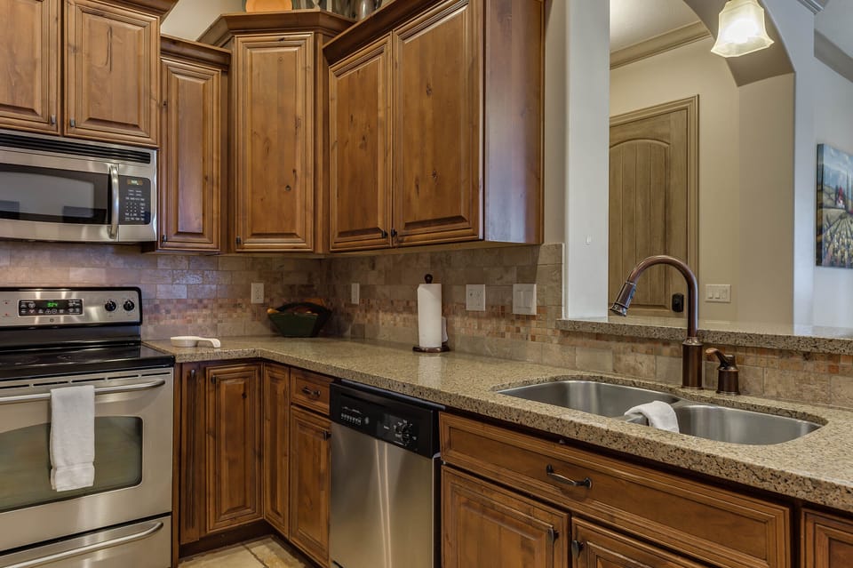Fully stocked gourmet kitchen featuring granite countertops