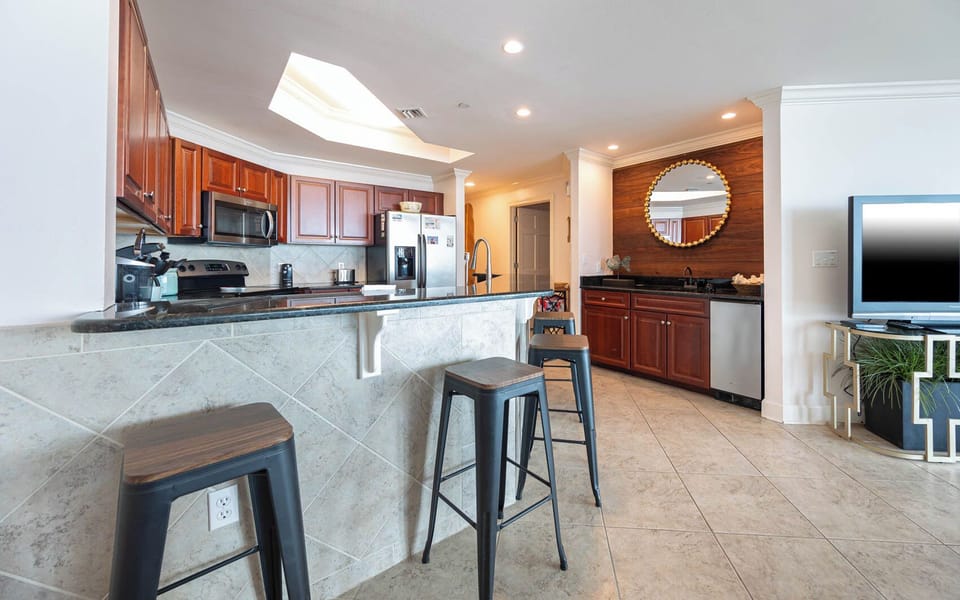 Sip your morning coffee at the breakfast bar and get ready for a beach day in this stylish space