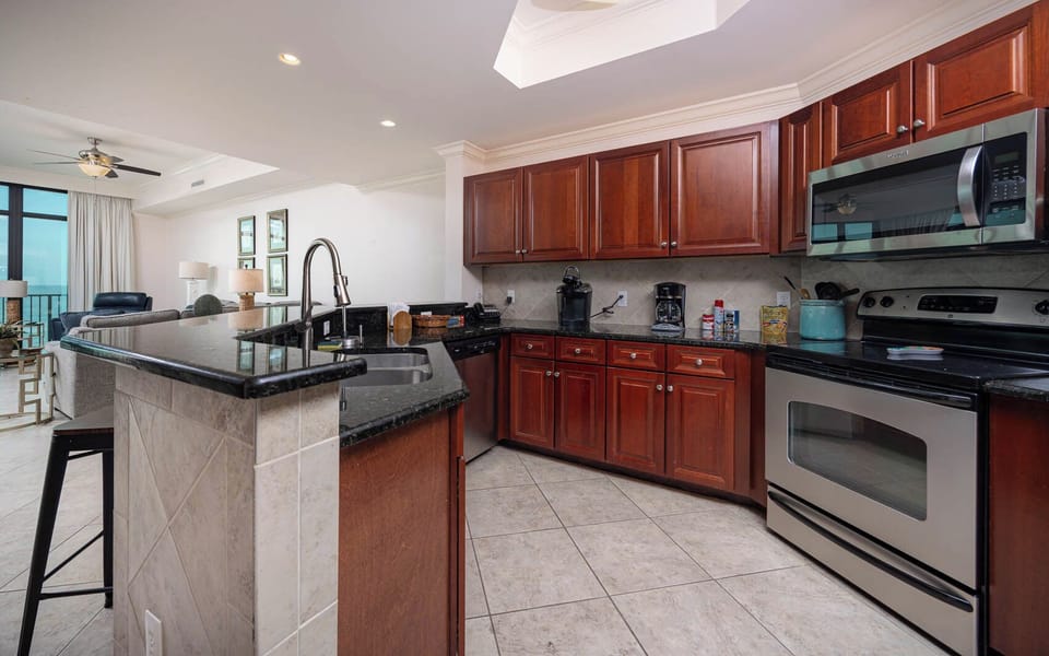 Prepare meals in this kitchen with elegant cabinetry, stainless appliances, and spacious countertops