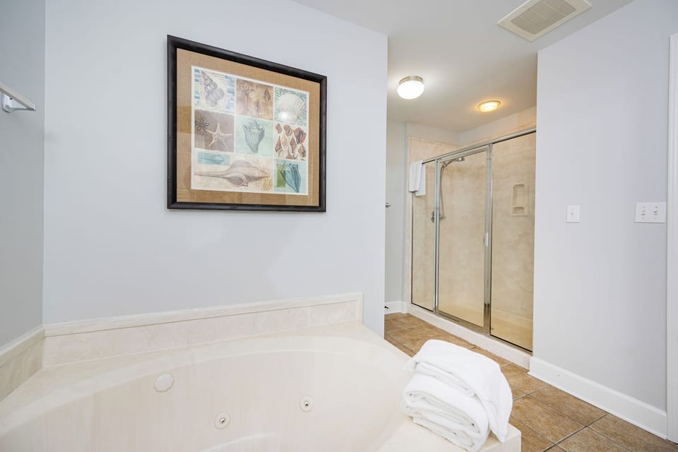 Indulge in relaxation in the master bath with a refreshing walk-in shower and soothing jetted tub