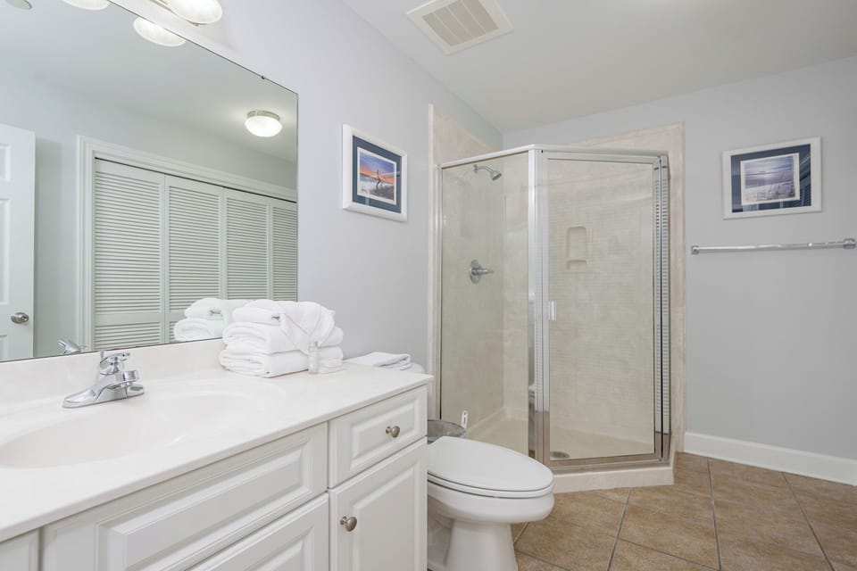 Refresh in this additional guest bath with a walk-in shower and laundry area with a washer and dryer in your rental
