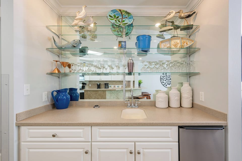 Mix refreshing drinks at the wet bar, surrounded by charming decor that adds a coastal vibe to your experience
