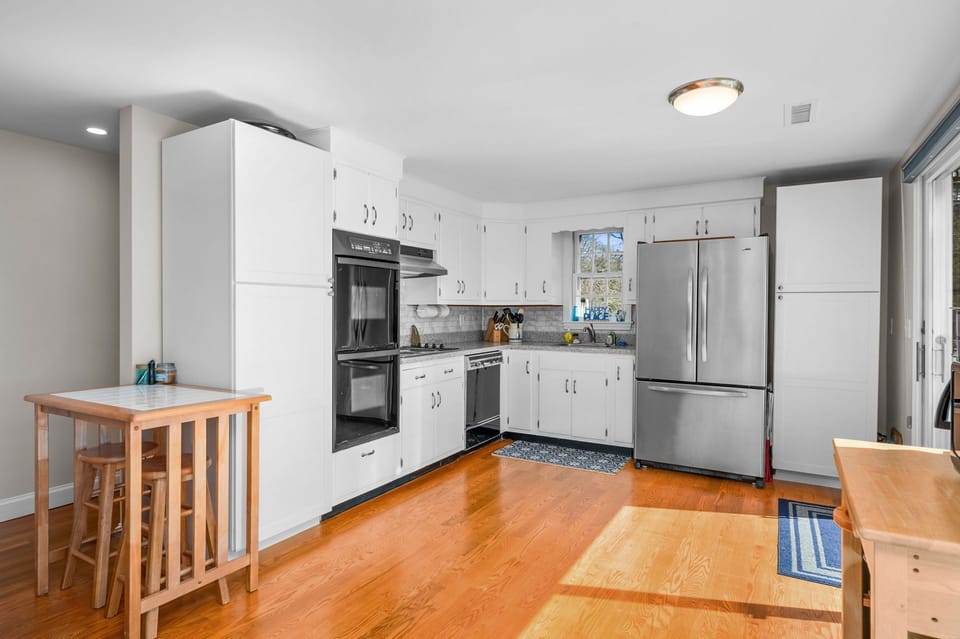 Fully equipped kitchen with dishwasher and extra seating at high top table serving as breakfast bar - 84 Cranberry Lane Chatham Cape Cod -  Ridgevale Retreat