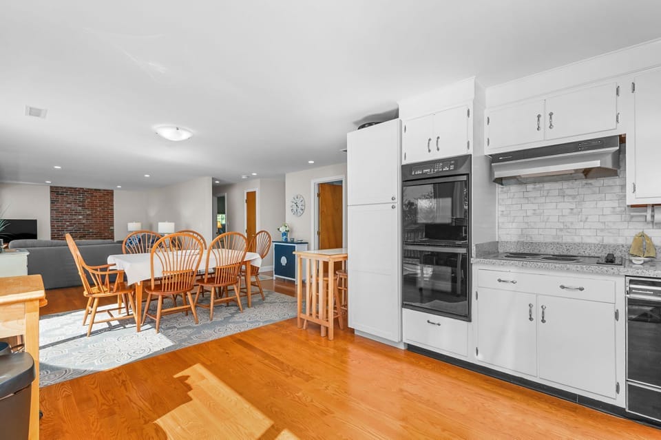 Dining area with traditional seating for six and two additional seats at the breakfast bar - 84 Cranberry Lane Chatham Cape Cod -  Ridgevale Retreat