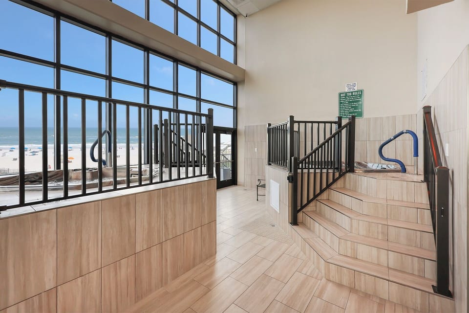 Soak in the indoor hot tubs at Phoenix II in Orange Beach with views of the beach just beyond the pool area