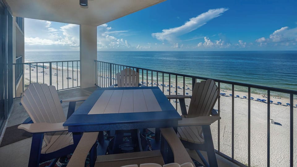 Relax on the balcony with comfortable seating and breathtaking views of the serene beach and tranquil waters