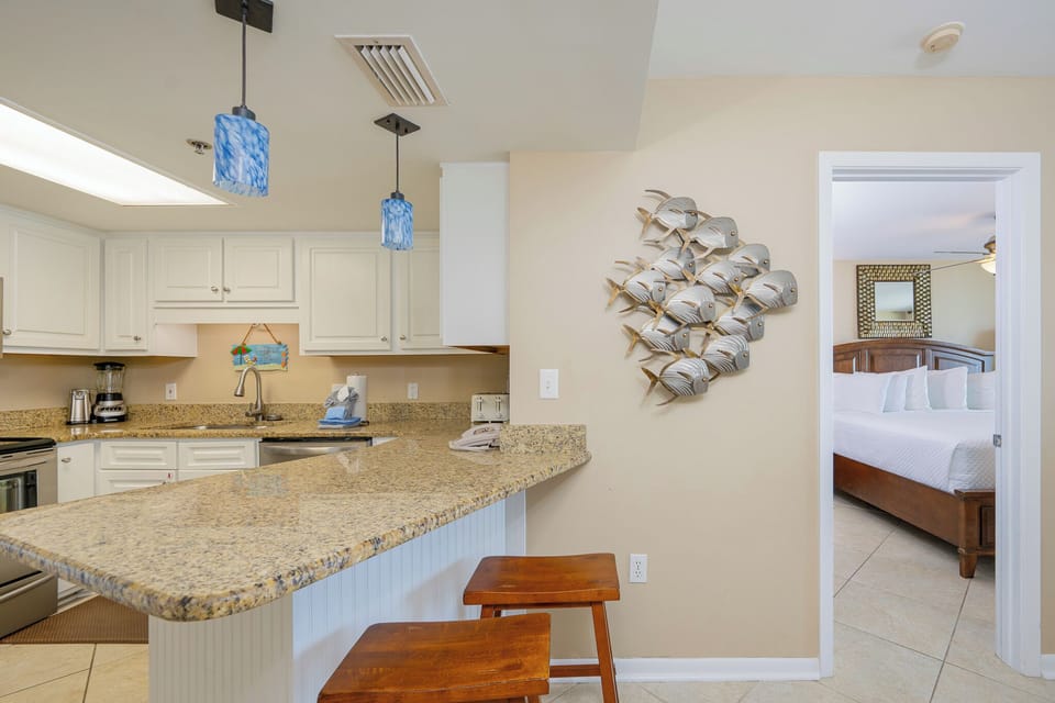 Soft light fills the kitchen where you sip morning coffee at the breakfast bar before exploring the shore