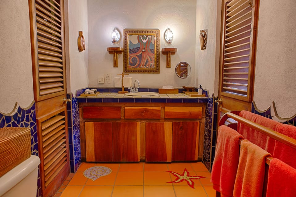The downstairs bathroom is conveniently located between two bedrooms.