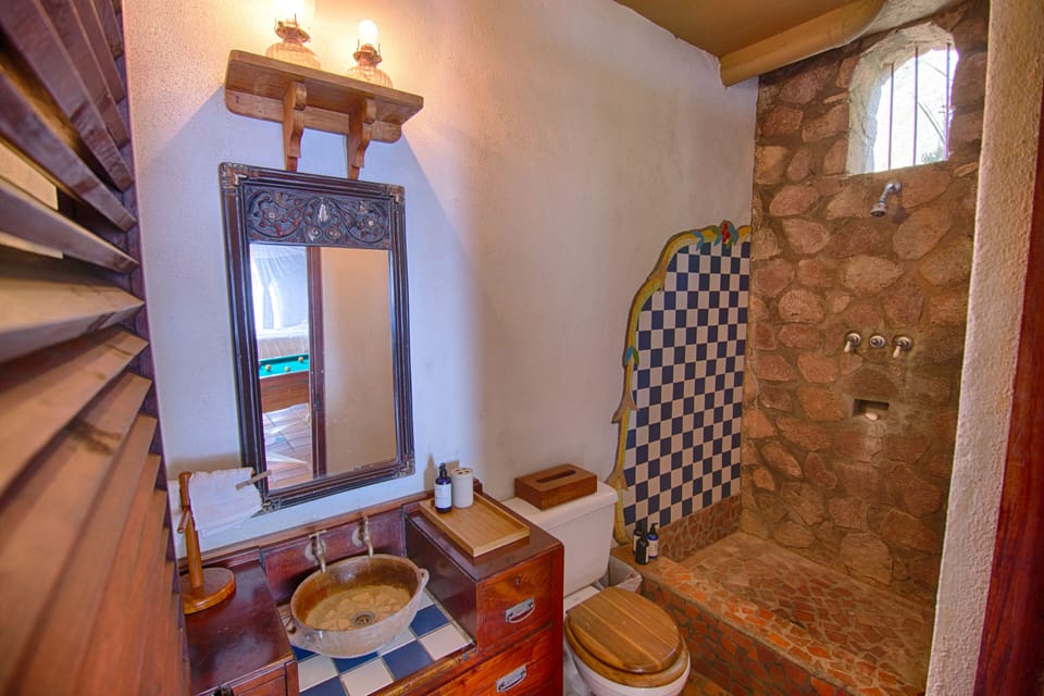 The third washroom employs the tile and antique elements as are elsewhere.