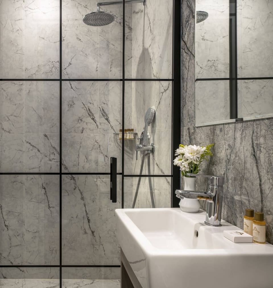 Shower, designer toiletries, hair dryer, slippers