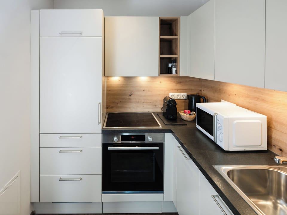 Delux Suite with balcony | Private kitchen | Fridge, highchair, cleaning supplies