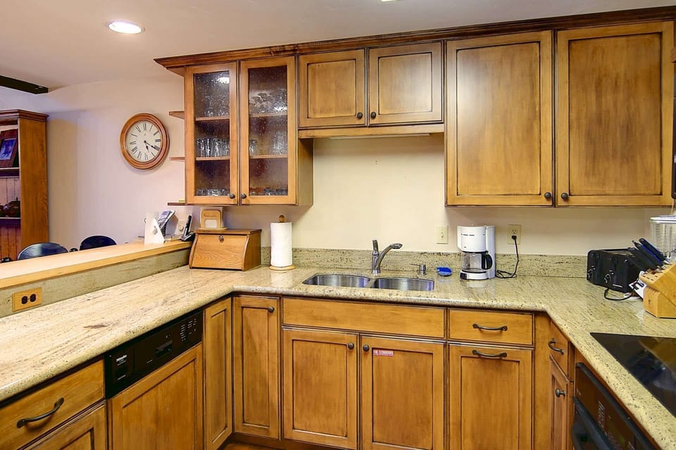 A beautiful updated kitchen with wood cabinetry and granite counter tops.