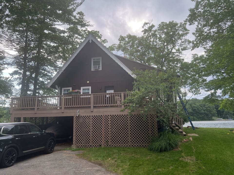 Back of the house w/large deck & outdoor cooking space. New driveway added 2024