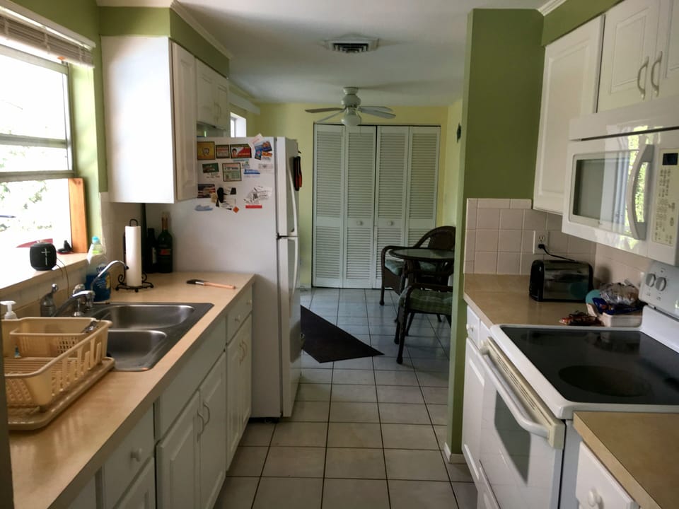 Walk through kitchen, pass through window over sink to the outdoor dining. 