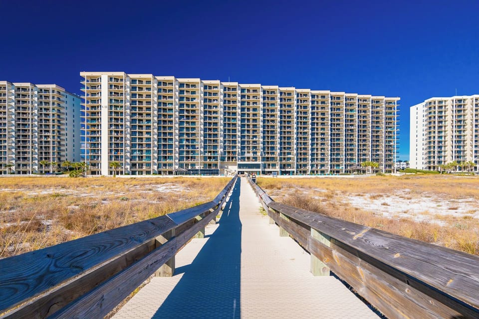 Walk along the boardwalk to your beachfront retreat at Phoenix VII, where stunning views and relaxation await just steps away