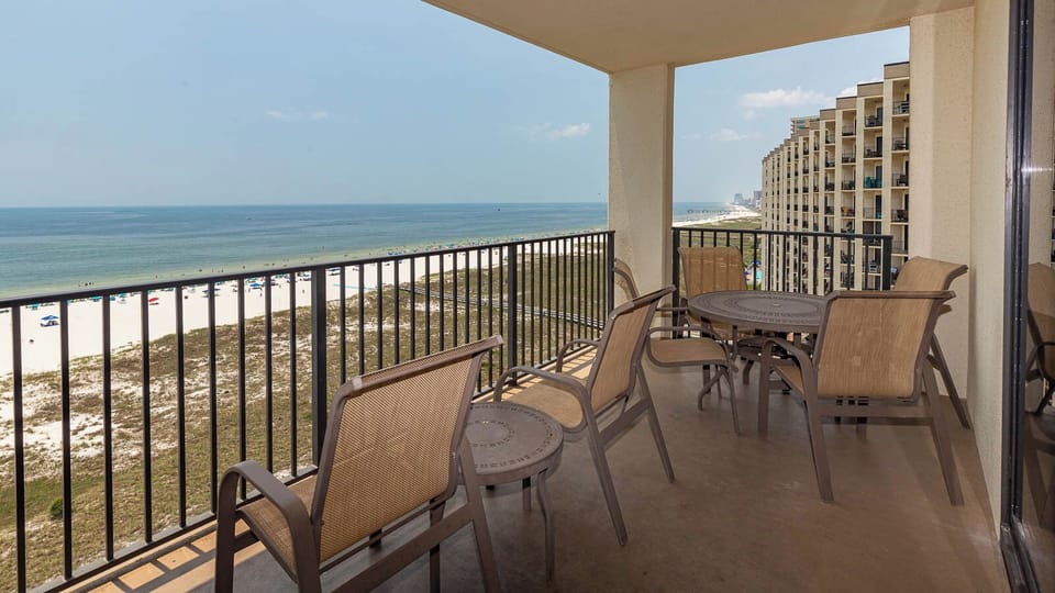 Balcony seating offers a serene view of the beach and gulf, perfect for relaxing and enjoying the coastal atmosphere