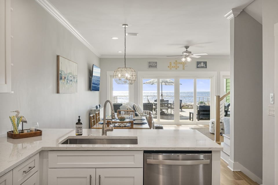 Sudsy sunsets & seaside scrubbing—washing dishes never looked so dreamy! 