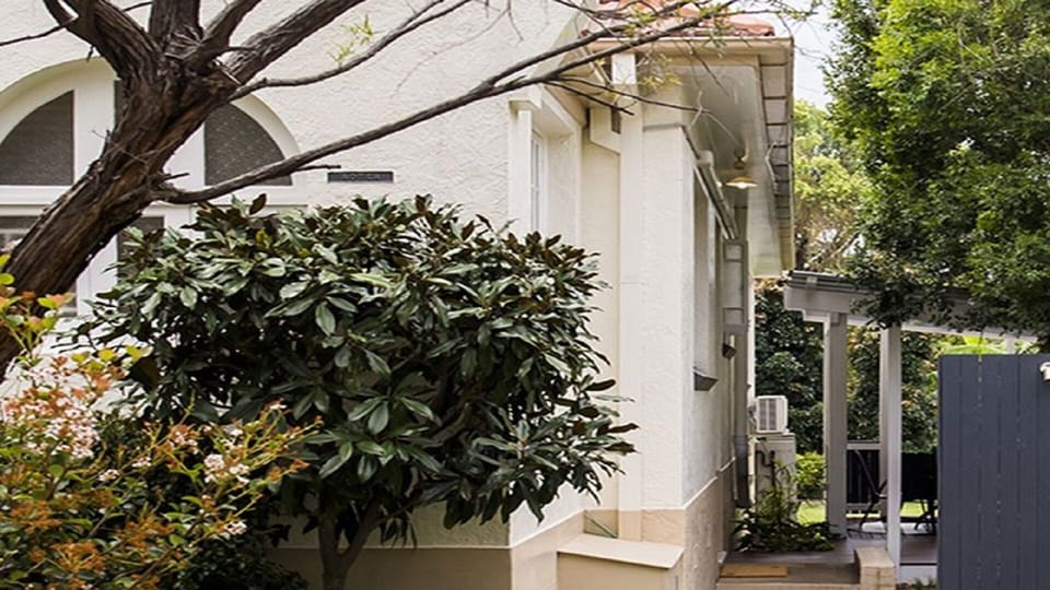 Apartment opens out to a tropical courtyard and lawn area.
