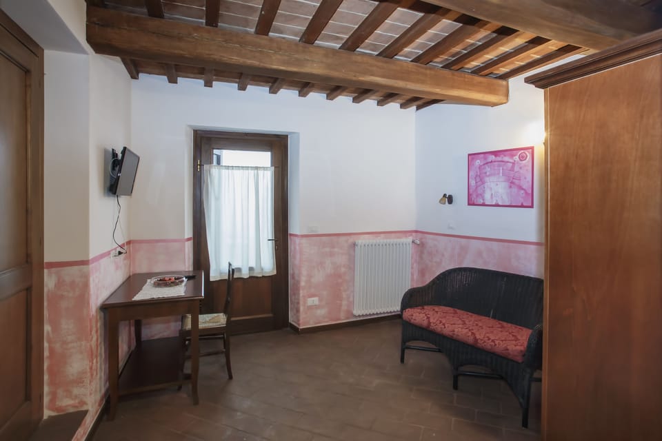 Deluxe Quadruple Room | Living area | Flat-screen TV