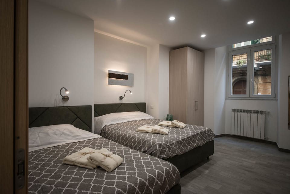 Comfort Quadruple Room | Memory foam beds, in-room safe, individually furnished, desk