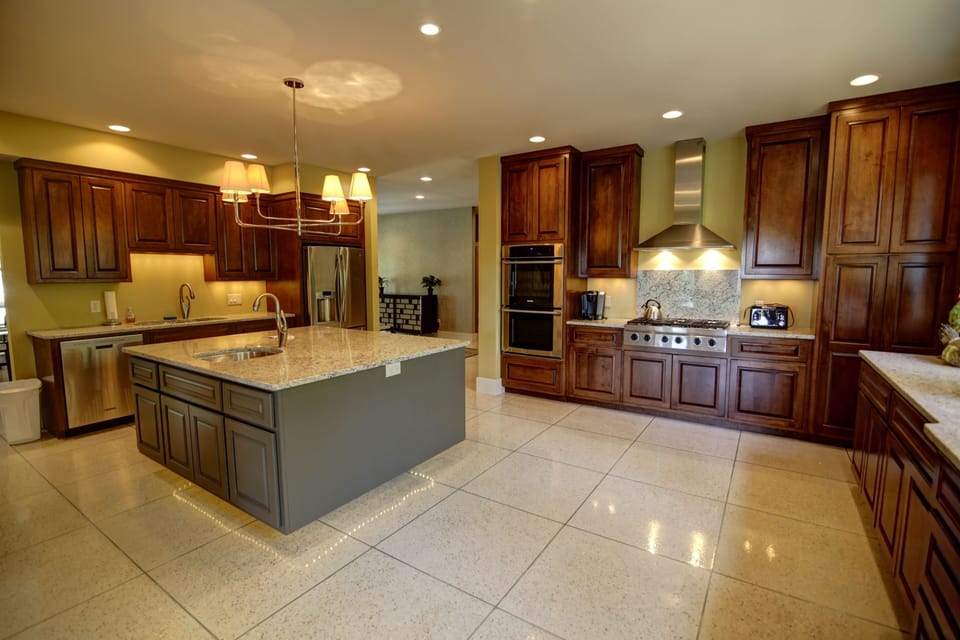 Central Kitchen with Granite Countertops and High End Stainless Appliances
