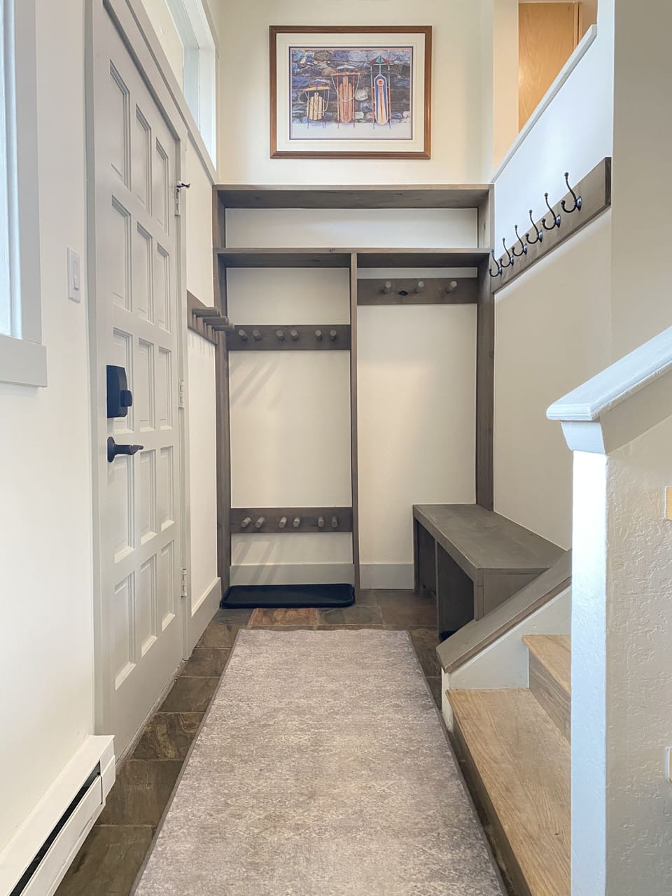 Entry hall with pegs and shelves for ski equipment and boots.