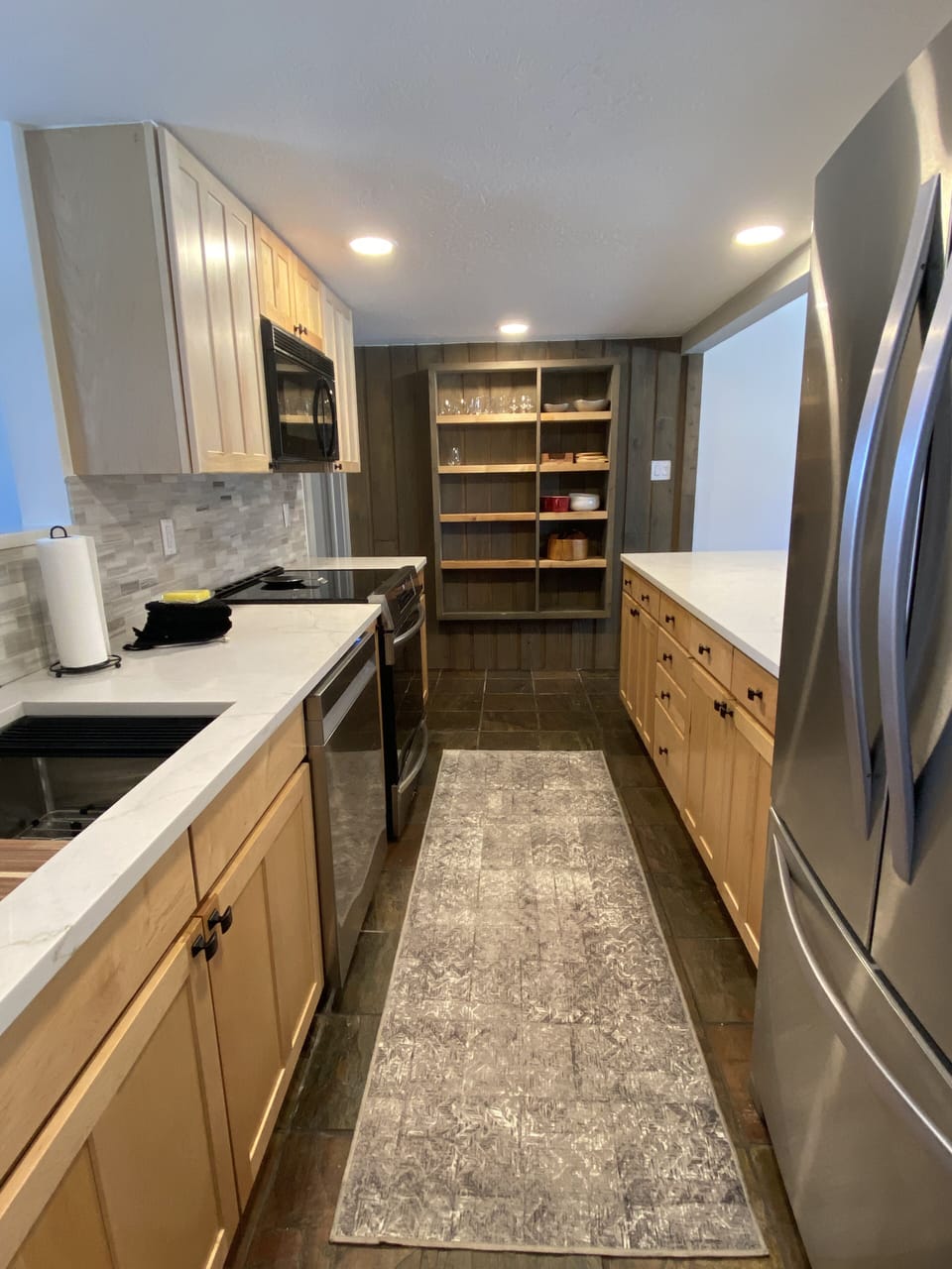 Walk around galley style kitchen wit counter area for serving
