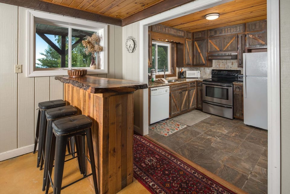 Second kitchen with bar seating, perfect for entertaining and serving guests on the lower level