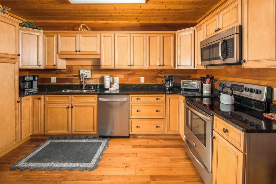 Spacious kitchen stocked with cookware, dishes, and everything needed for meal preparation