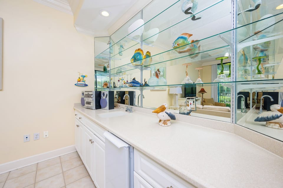 Embrace coastal vibes as you mix refreshing drinks at the stylish wet bar, ideal for lively gatherings