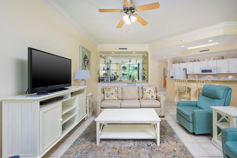 Relax on the cozy sofa with a queen sleeper in this inviting family room with beautiful balcony views