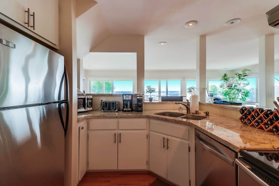Experience convenience and style in the second kitchen, complete with stainless steel appliances and a granite countertop.