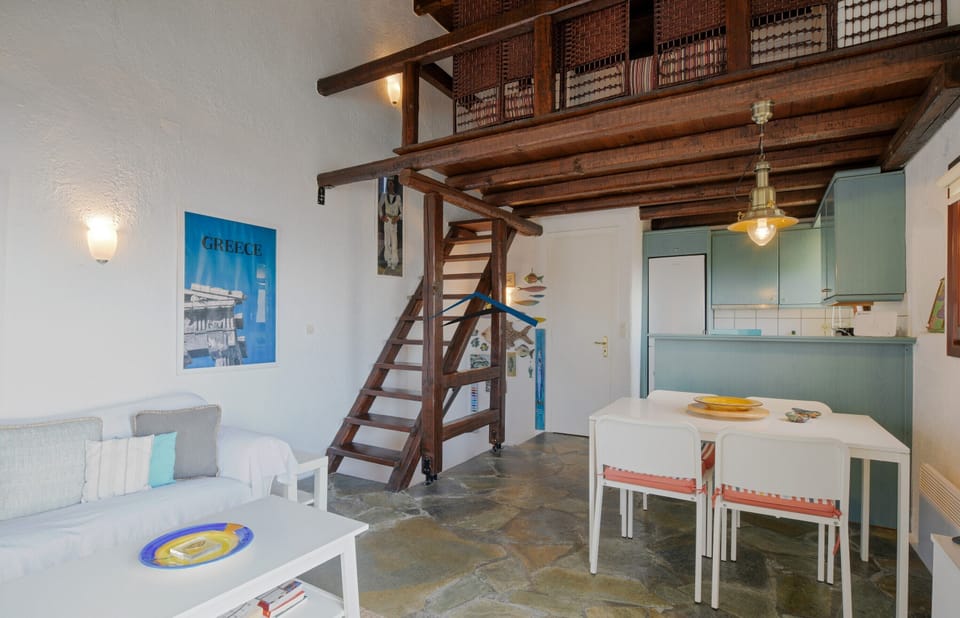 The dining area and stairs leading up to the loft