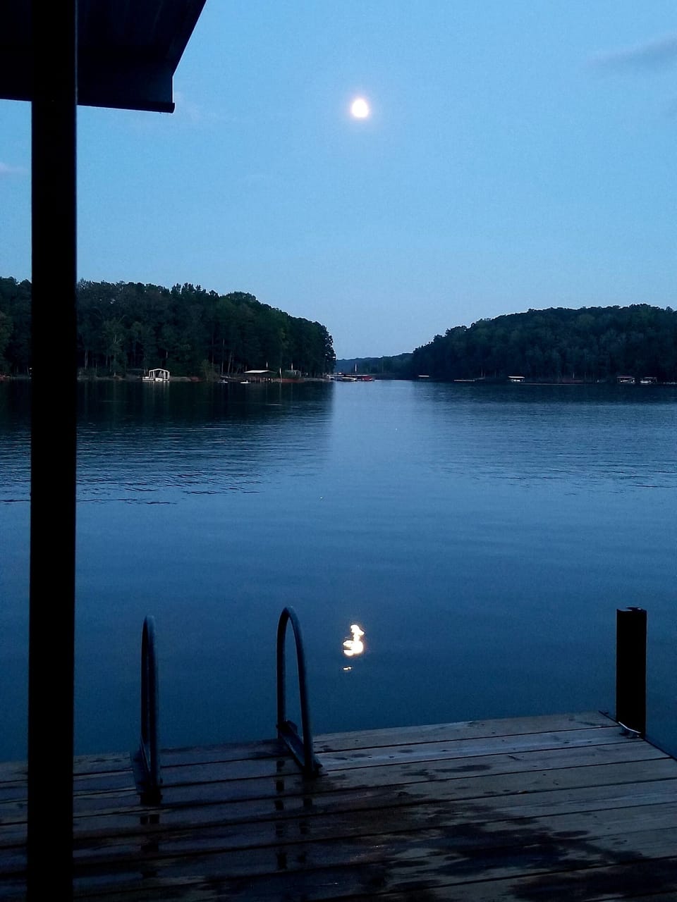 Bright full moon rising on the lake - early fall. Water is still good for swim.