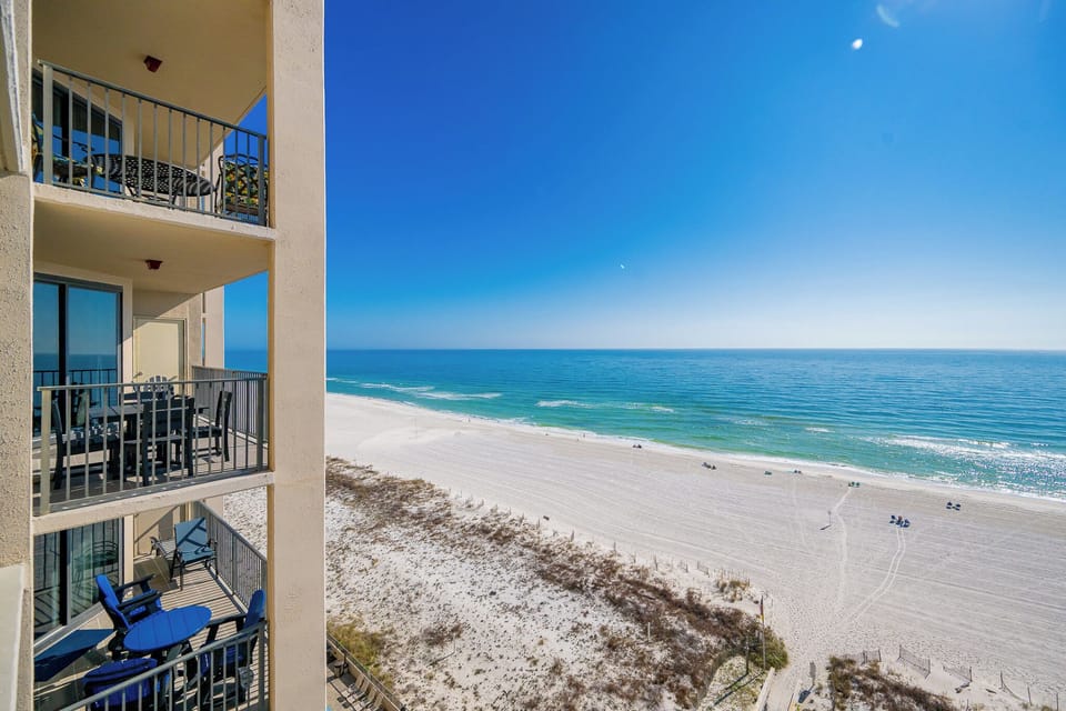 Your balcony reveals endless blue skies and gentle waves along the white beach coast