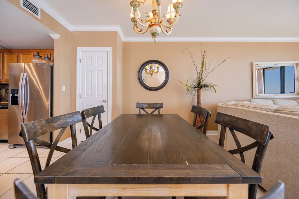 The dining area invites you to gather around the dark wood table for lively conversations and meals together