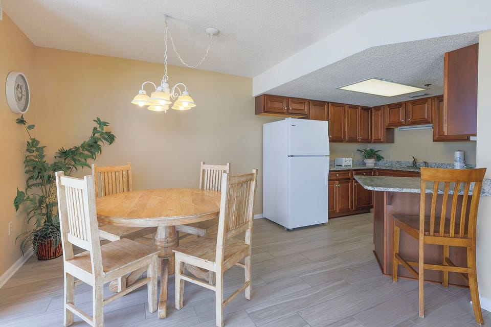 Gather around the wooden dining table, surrounded by warm decor and a cozy atmosphere