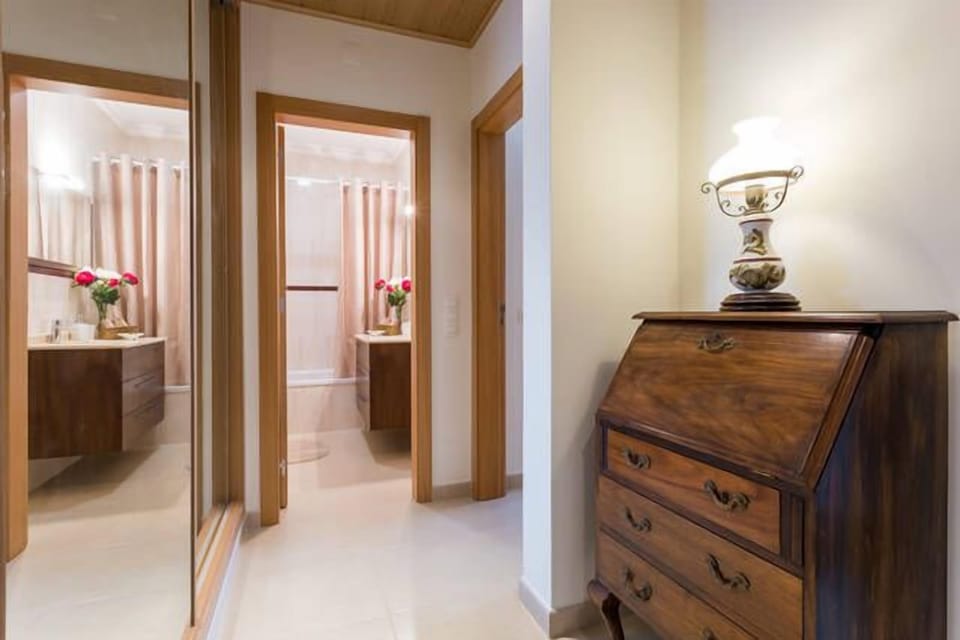 View of bathroom from hallway with full length mirrored cupboards