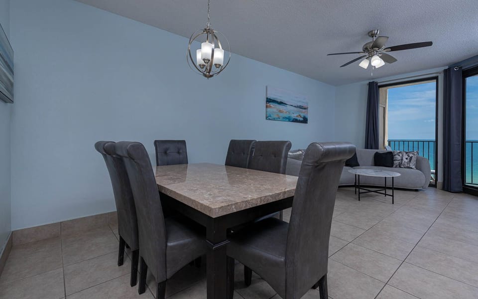 Gather around the stylish dining table, perfect for shared meals and enjoying the coastal view through large windows